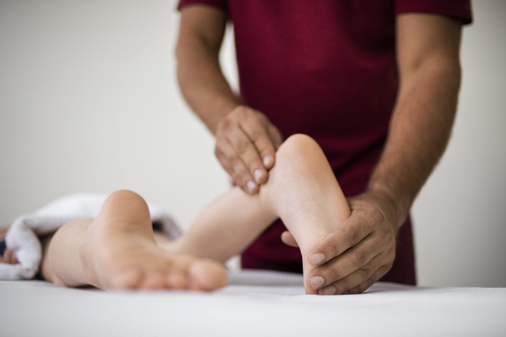 Podiatrist assessing foot